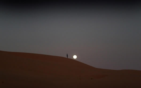 sun behind the sand dunes