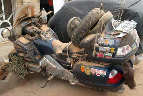 motorbike covered in sand during a sandstorm