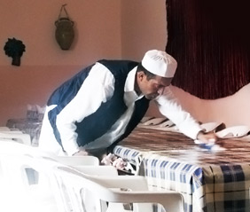 a Libyan worker cleaning a table