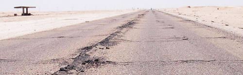 cracks and holes in a tarmac road