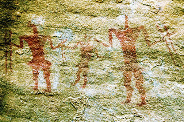 cave painting of two figures holiding double sticks, in wadi tashwinat