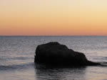 a view of the red sky behind the beach