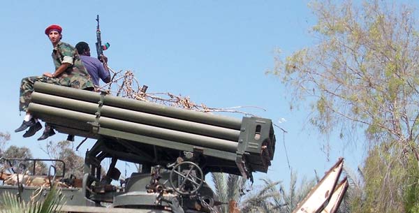 a rebel sitting on a missile launcher