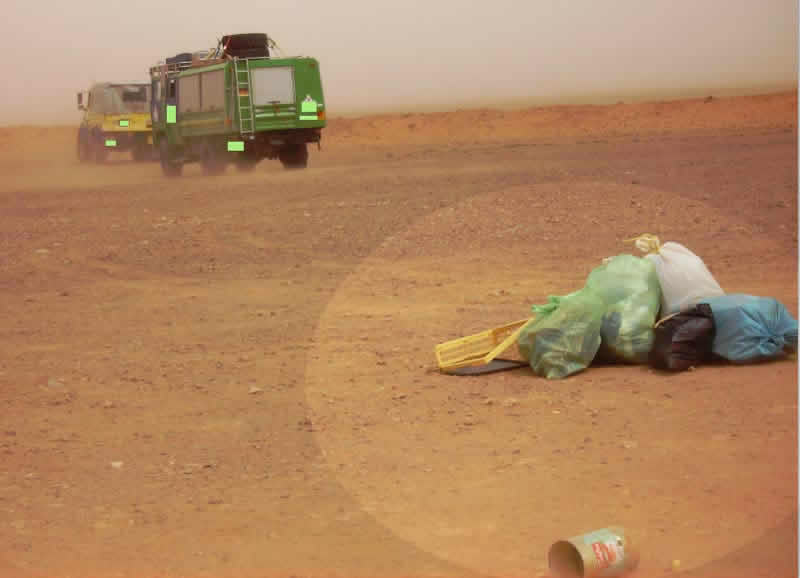 some European tourists throwing rubbish randomly in the Sahara