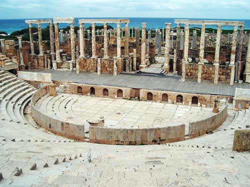 the view of the theater with the sea in the background