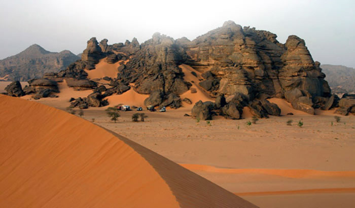 acacus rock formation with sand dunes in the foreground