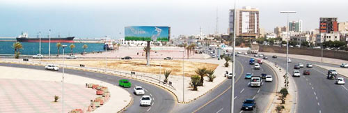 a view of Tripoli showing roads withs cars, the sea and some buildings