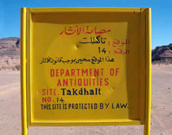 takdhalt site sign board, yellow with blue sky background, showing the name of the protected site