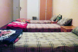 a photo of three beds from the youth hostel in cyrene