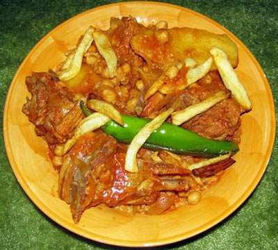 couscous with meat, vegetables and fried green pepper on top