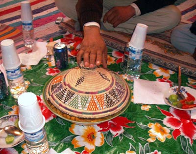 couscous meal, covered with traditional straw-made coloured  pyramidal cover