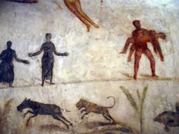 wall paintings: a man carrying a dead man, a lion chasing an animal