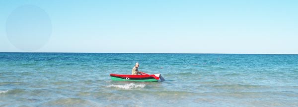 a boat painted in libyan flag in blue sea water