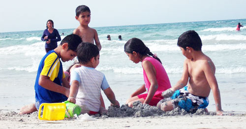 children playing with sand by the beach of Zuwarah